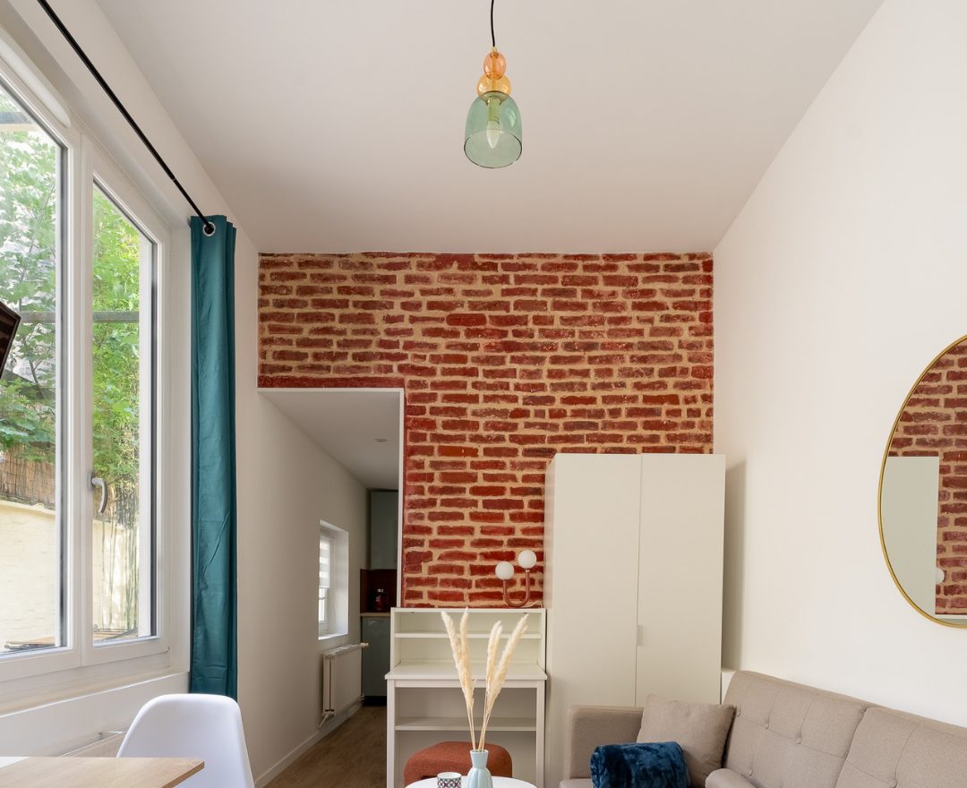 Exposed brick wall and cement tiles after renovation, rue Pierre Martel, Lille - RIVEX